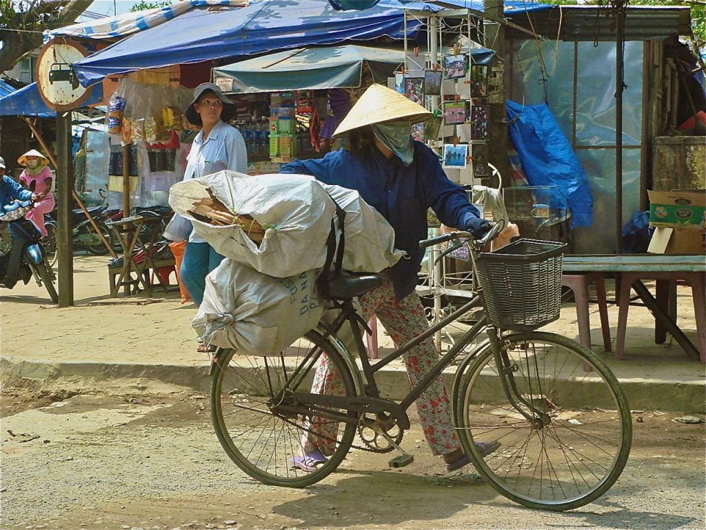woman with bike and bundles